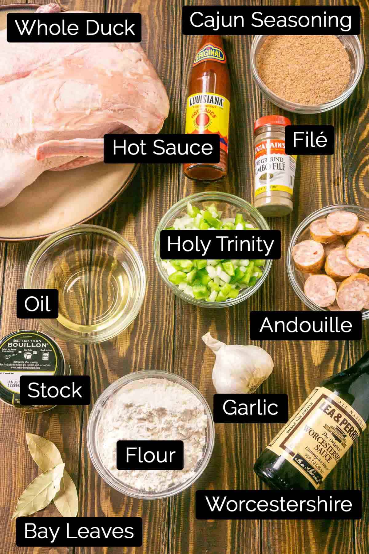 The duck gumbo ingredients with labels on a wooden board.