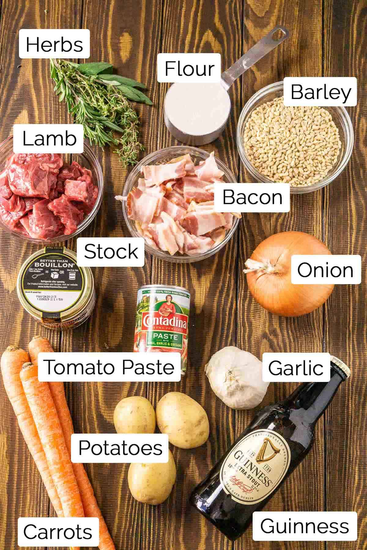 The Guinness lamb stew ingredients with labels on a wooden surface.