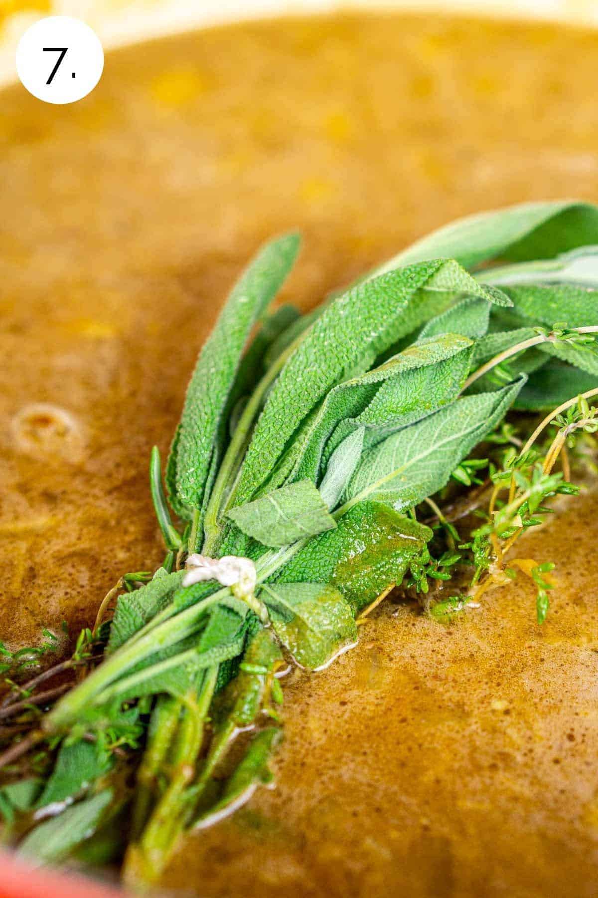 The herbs tied in a bundle on top of the stew before simmering.