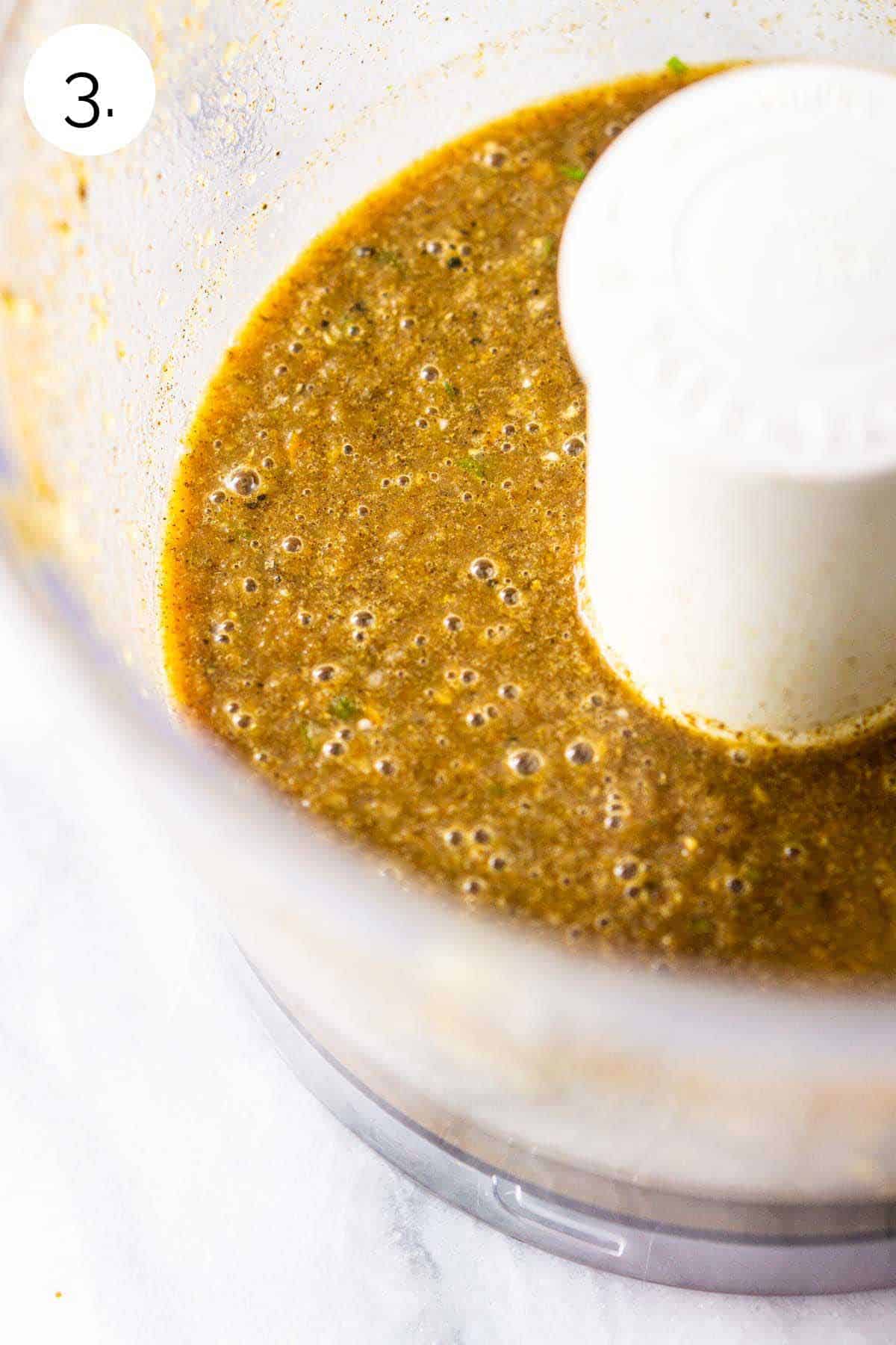 The jerk marinade in a food processor after it's been blended with the liquid ingredients.