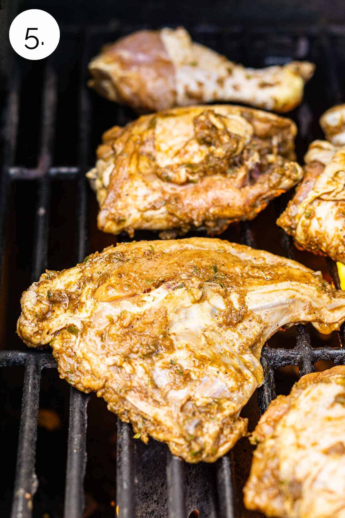 The chicken with the skin side down on a hot grill before closing the lid.