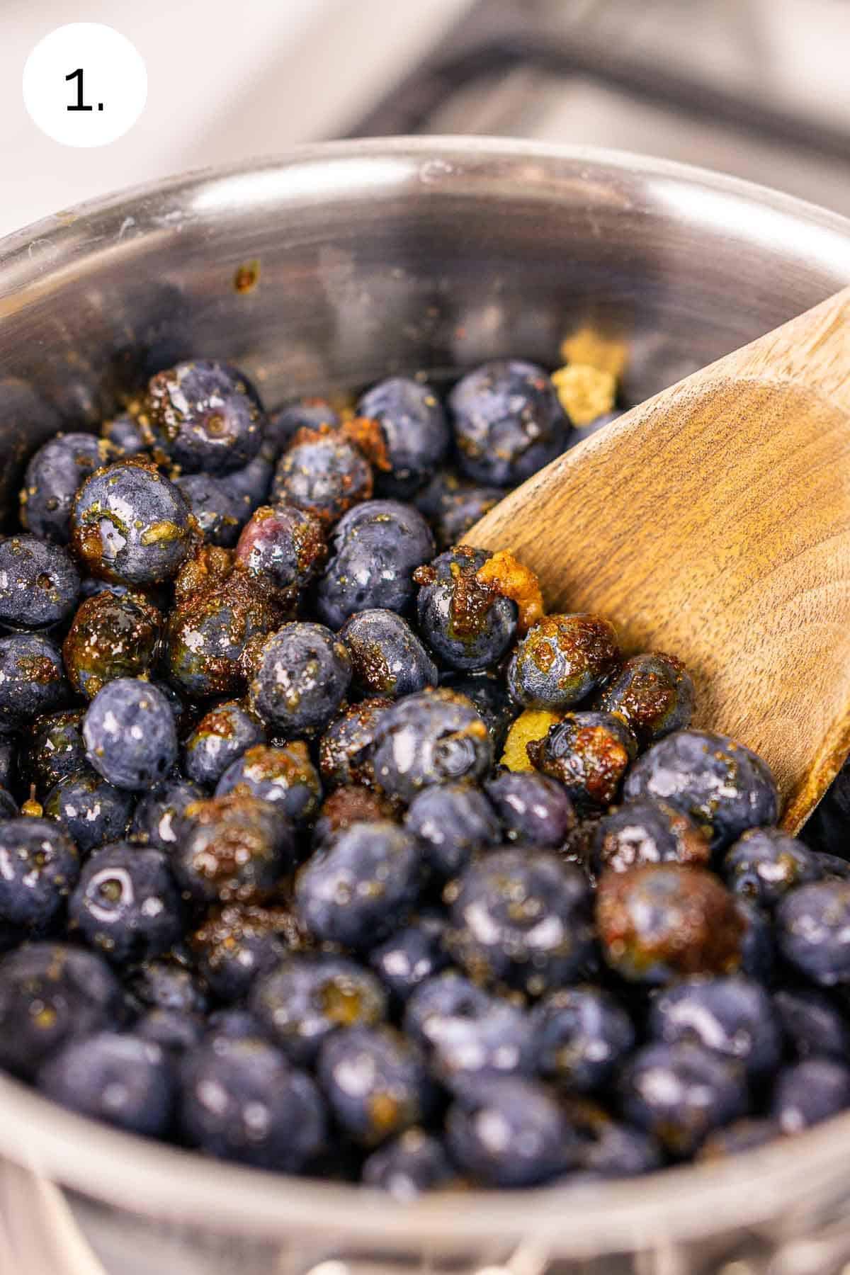 The blueberries and other ingredients in a medium saucepan before cooking down into a sauce.
