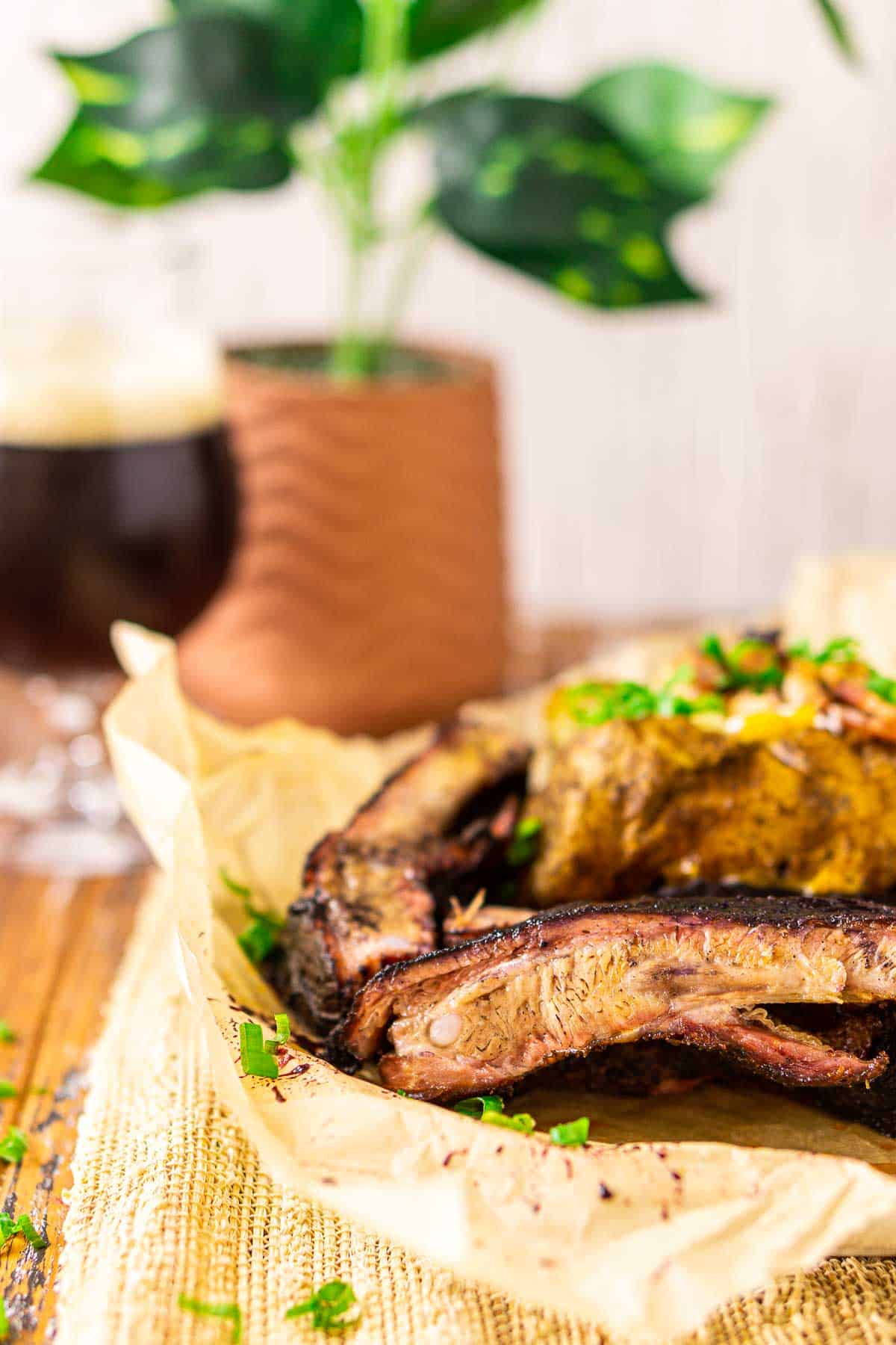 A close-up shot of the pellet grill ribs on a plate with brown parchment paper underneath.