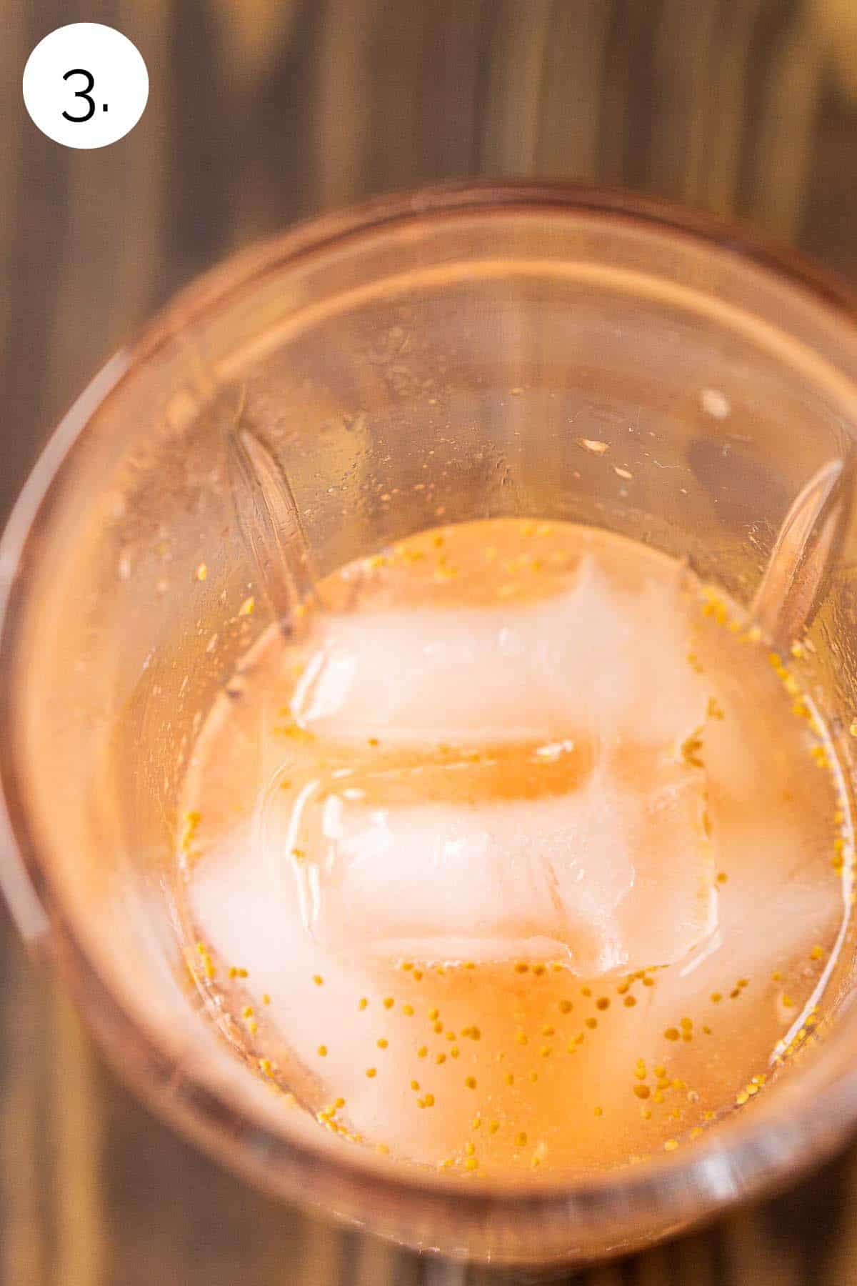 The muddled figs with the rest of the ingredients and ice in a crystal cocktail shaker before mixing.