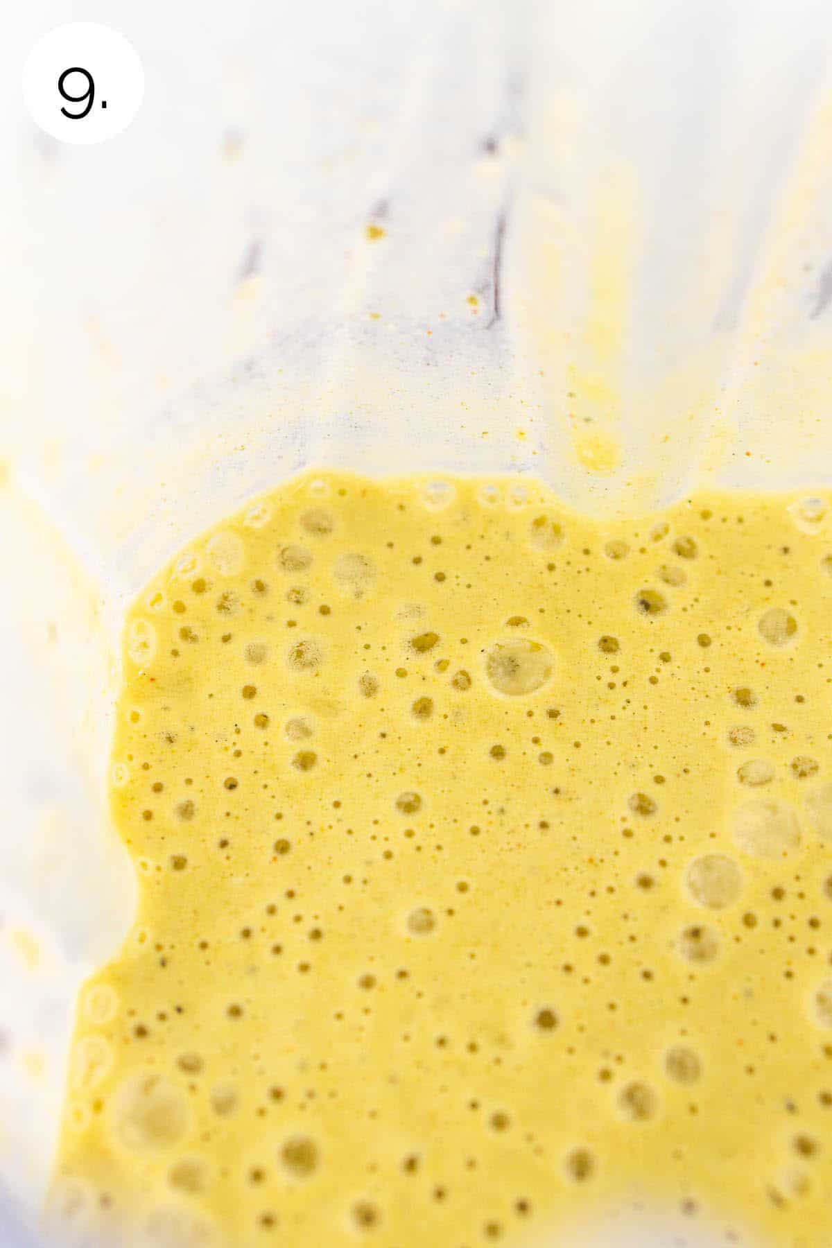 The verde sour cream sauce in a blender after processing until nice and smooth.