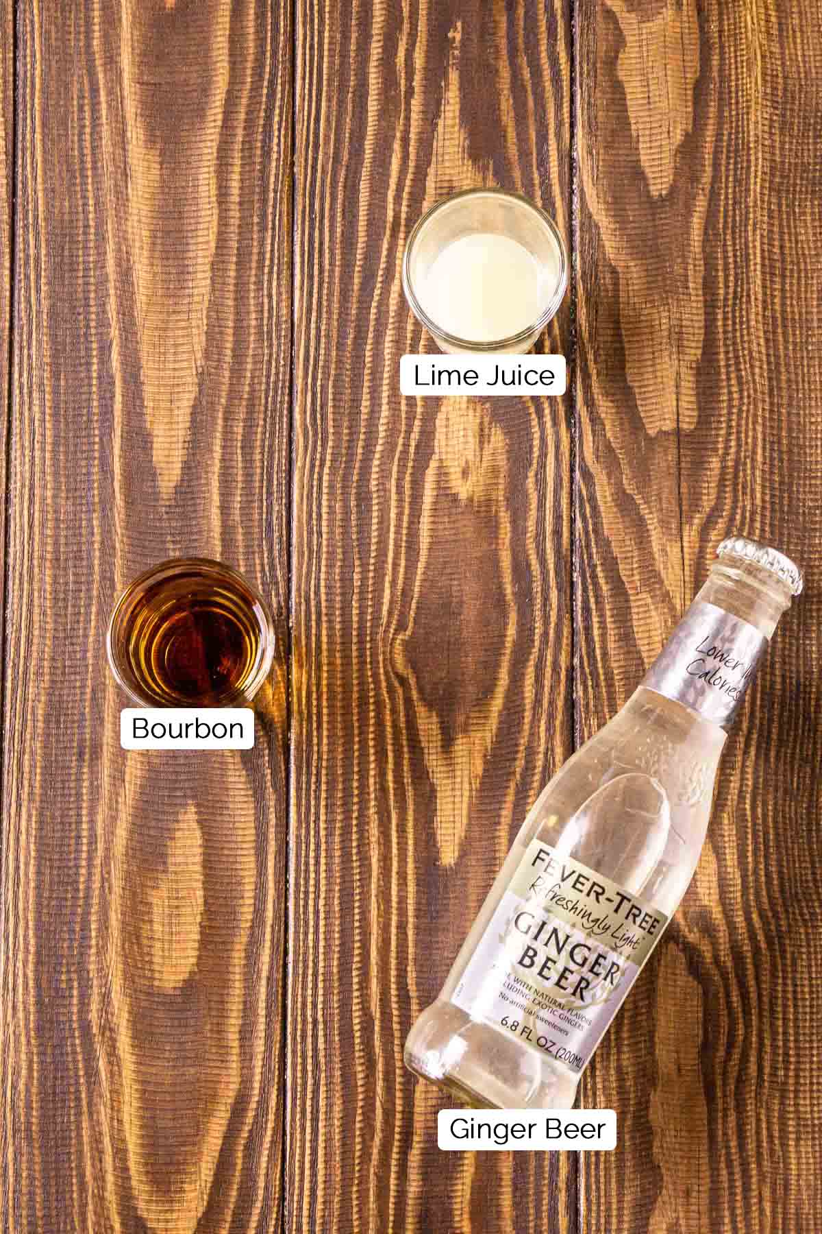 The three mule ingredients on a brown wooden surface with black and white labels.