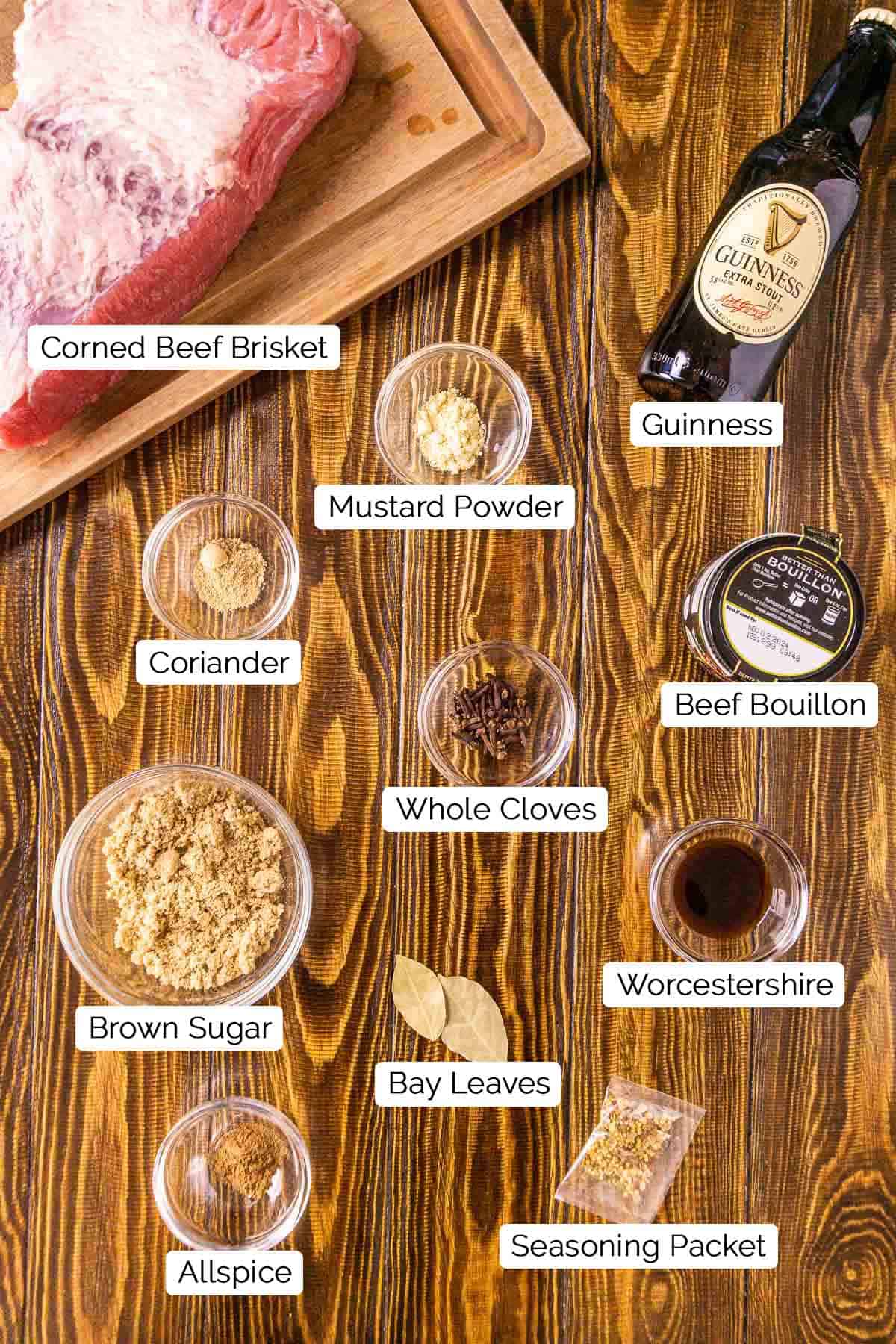 The ingredients on a brown wooden surface with black and white labels underneath the various items.