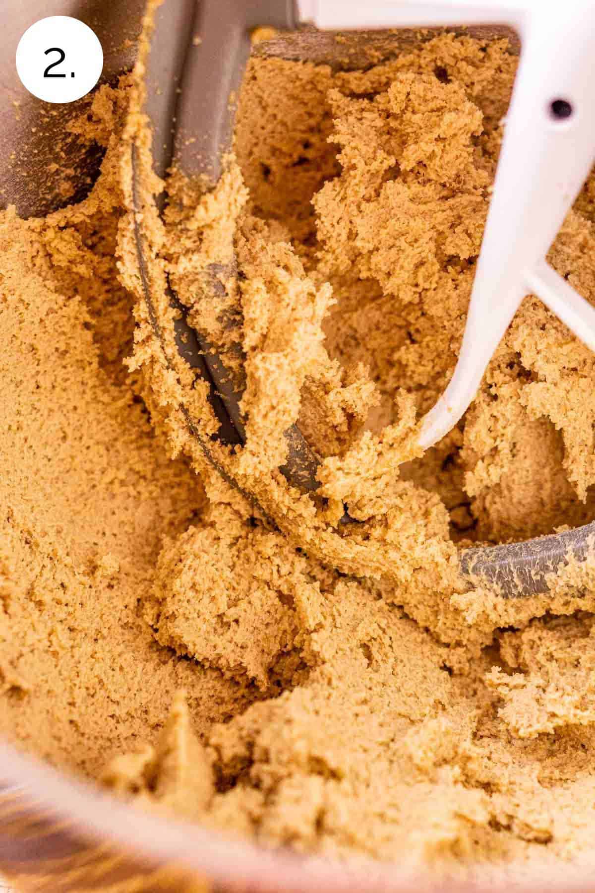 The butter, sugar and extracts in a large stainless steel mixing bowl after it's been mixed until light and fluffy.