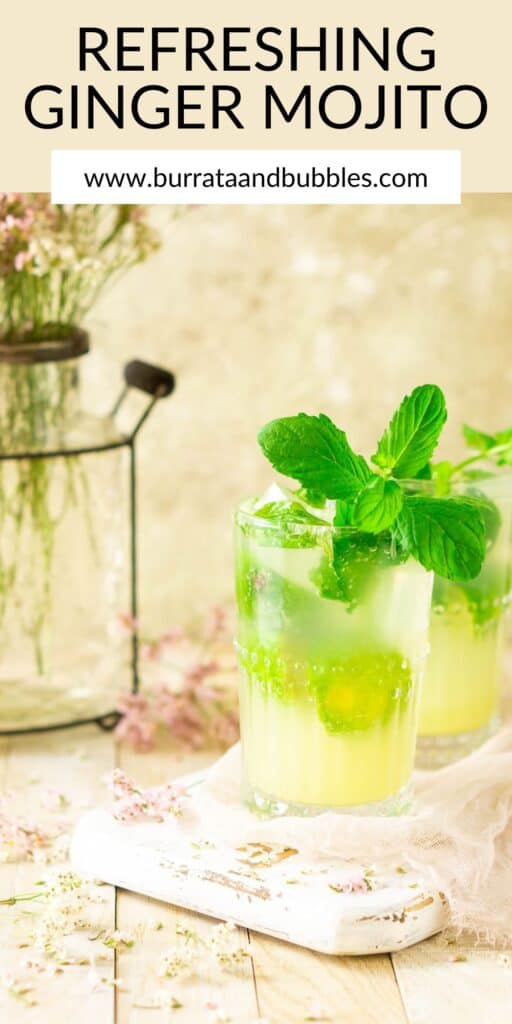 A ginger mojito on a cream-colored surface with flowers around it and text overlay on top.