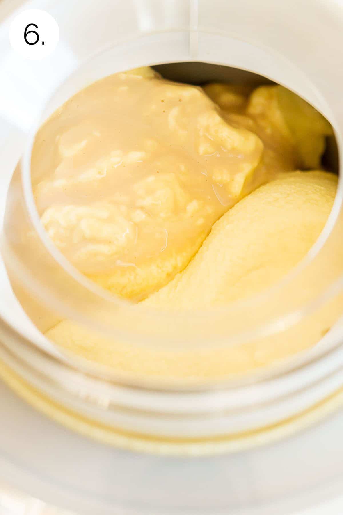 The Baileys Irish Cream on top of the custard base as it churns in a white ice cream maker.
