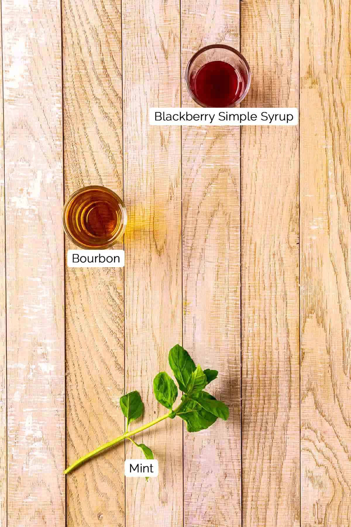The three ingredients on a cream-colored wooden board with white and black labels.