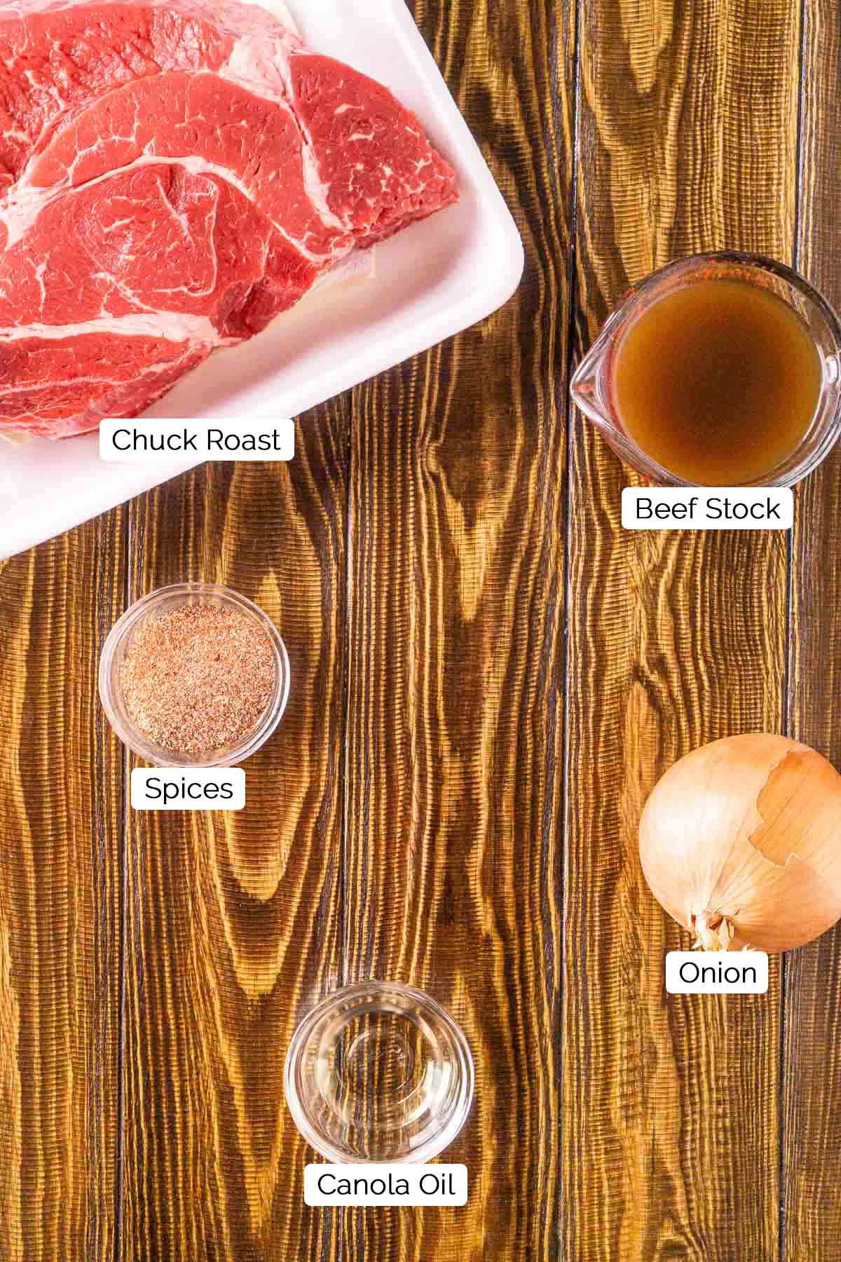 The beef ingredients on a brown wooden surface with black and white labels.