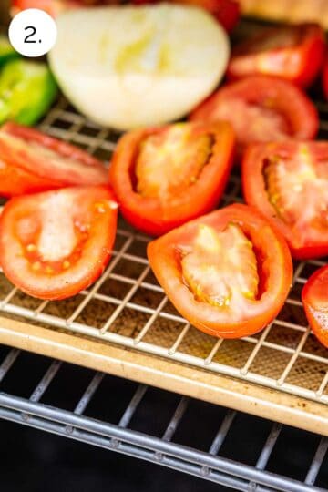 The vegetables on a gold sheet pan with a wire rack inside the smoker before closing the lid and cooking.