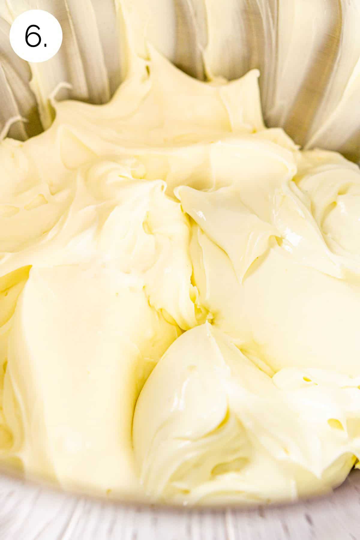 The cream cheese mixture in a large mixing bowl after the sour cream, vanilla and salt have been incorporated.