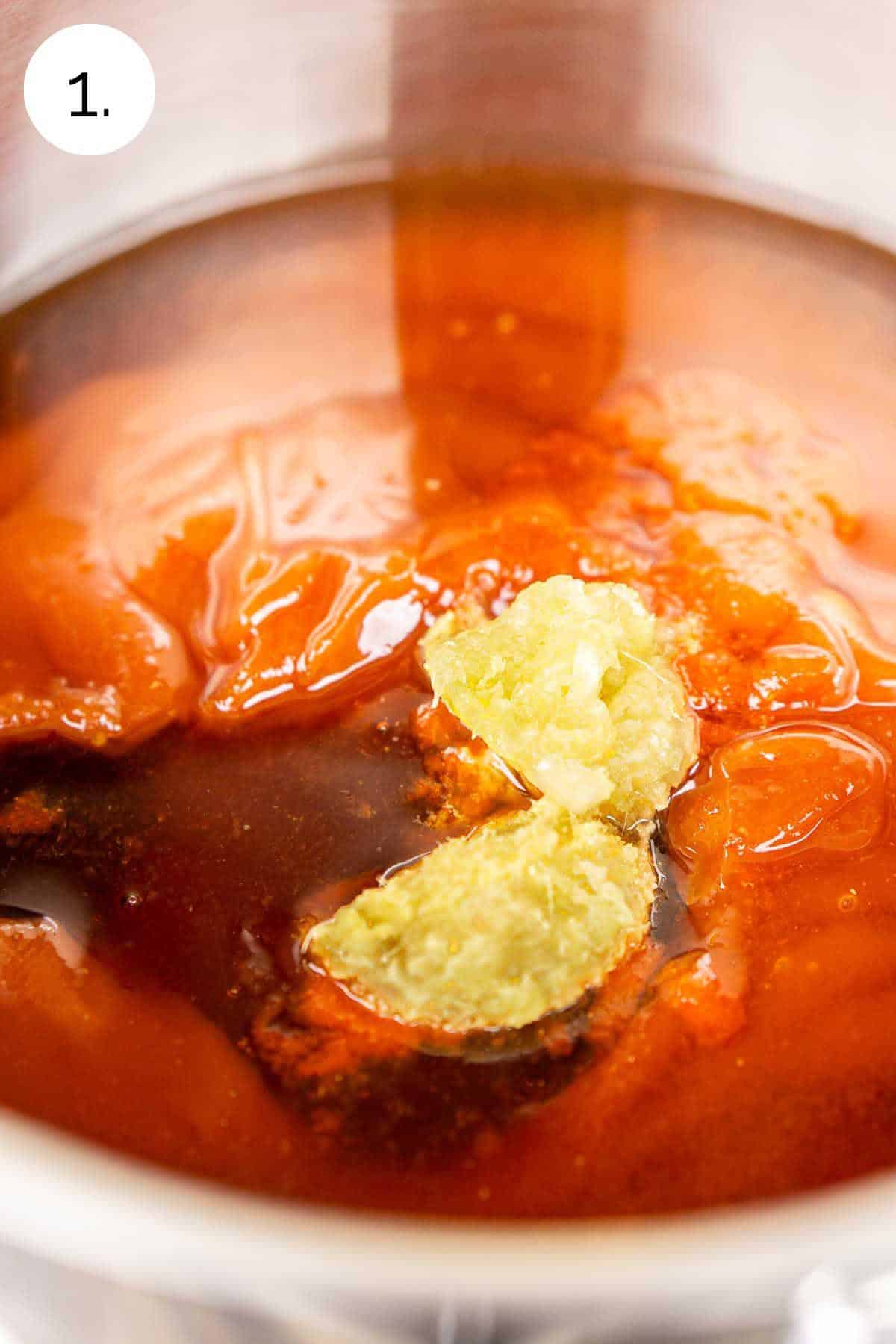 The sauce ingredients in a small stainless steel saucepan on the stove-top range before stirring to combine them.