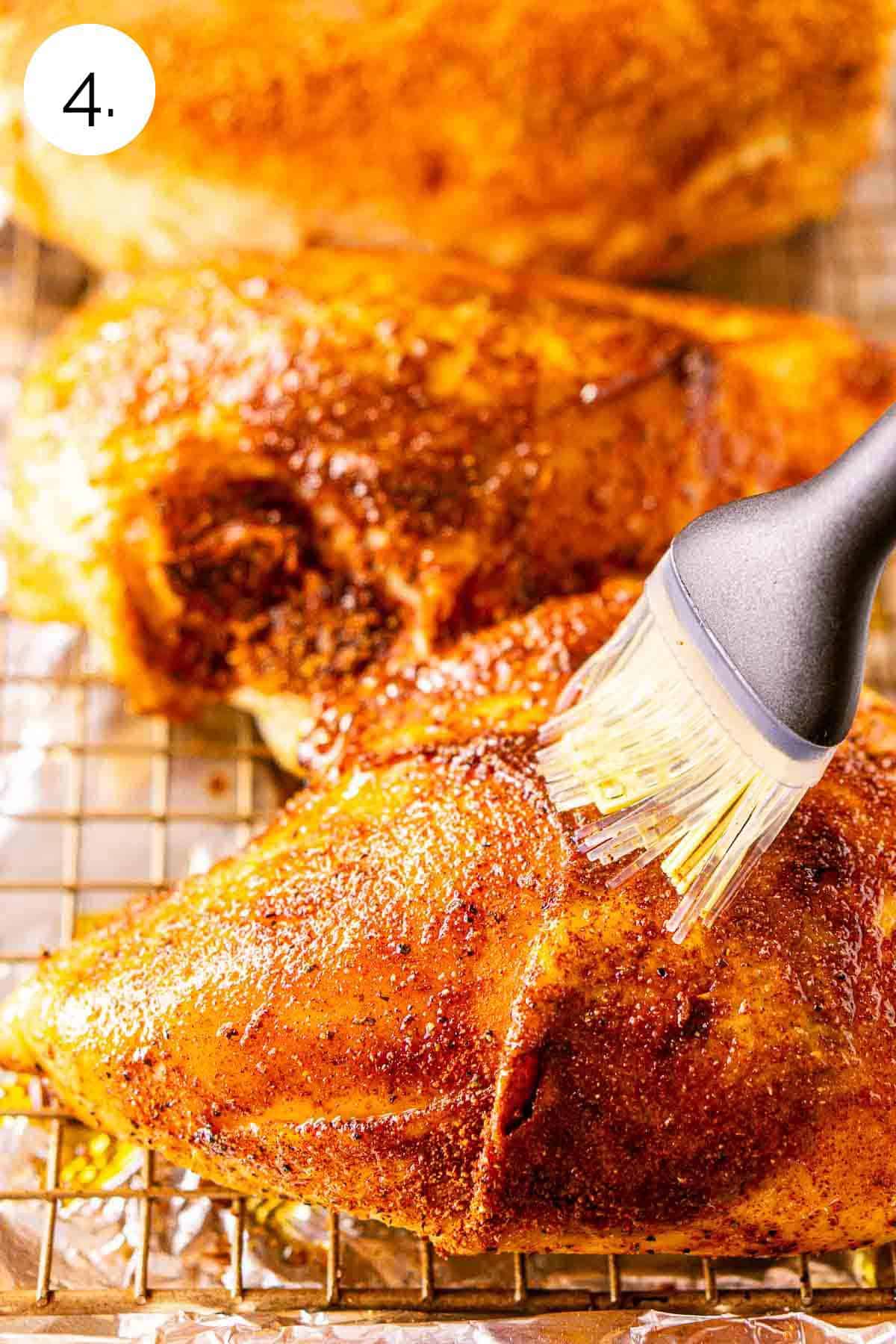 A silicone brush coating the chicken skin with a layer of oil to help crisp the skin in the next phase of smoking.