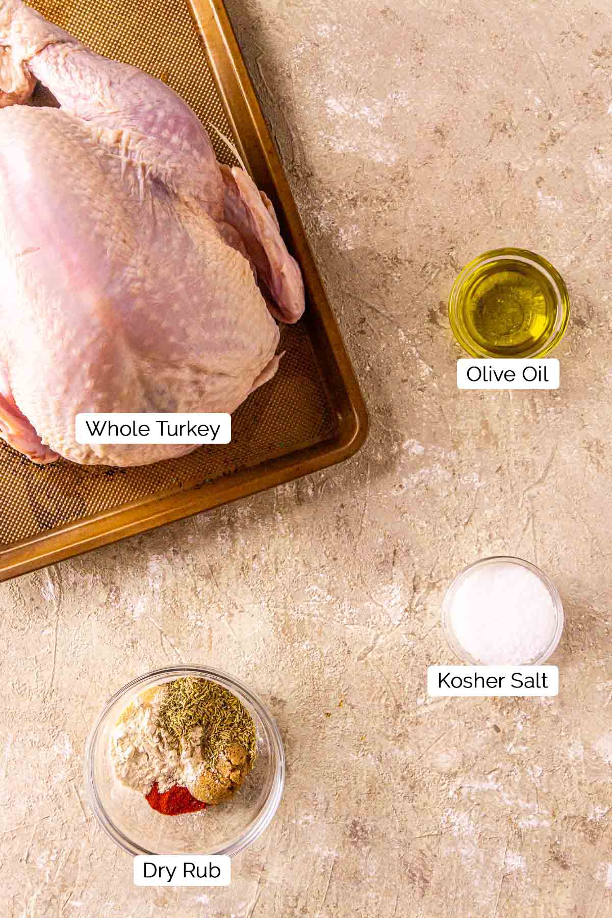 The ingredients for smoking the turkey on a cream-colored surface with white and black labels by the items.