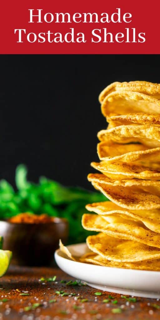 A stack of homemade tostada shells with cilantro and chili powder scattered around it with text overlay on top of the image.